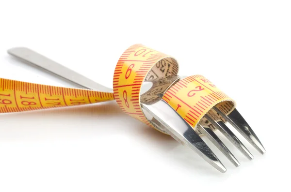 Concetto di dieta con forchetta metallica con metro — Foto Stock