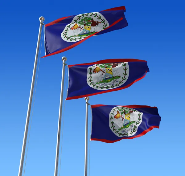 Tre flaggor Belize mot blå himmel. — Stockfoto