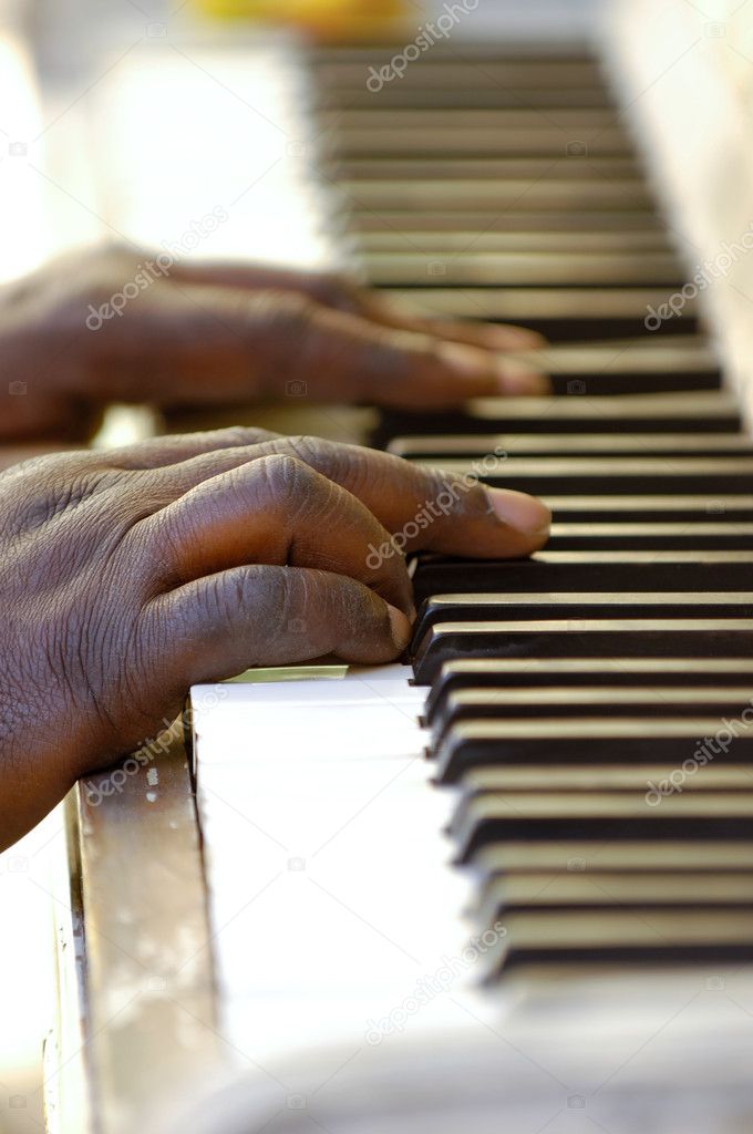 Hands and old piano