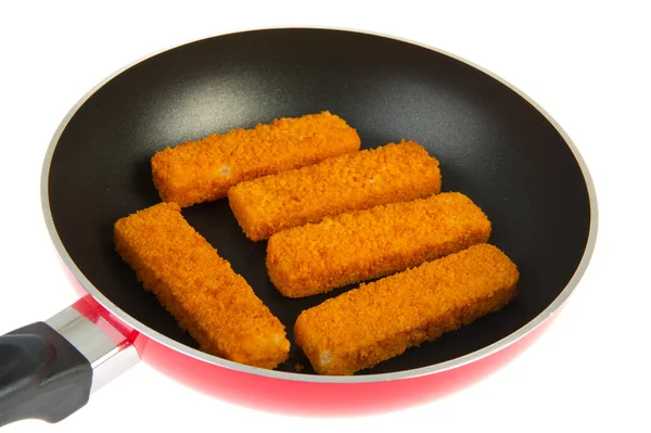 Red frying pan with fish sticks — Stock Photo, Image