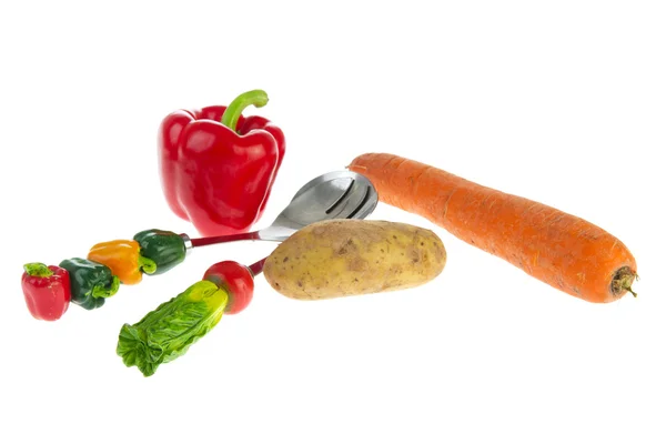 Various vegetables and funny spoons — Stock Photo, Image