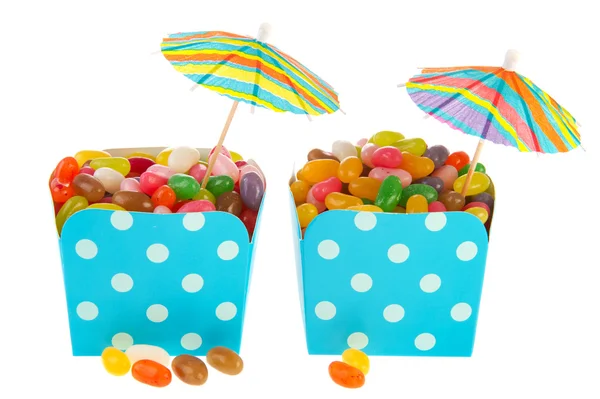 Caixas de doces coloridos com guarda-sóis — Fotografia de Stock