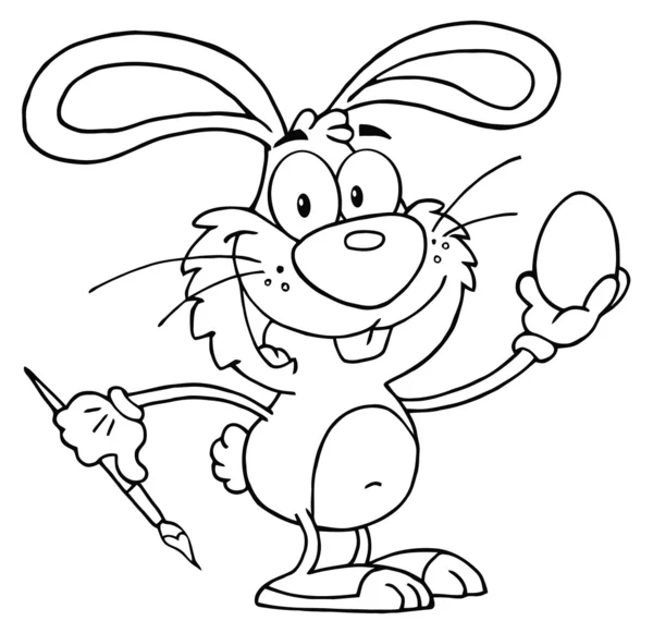 Обрисованный пасхальный кролик рисует яйцо — стоковое фото