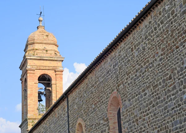 Clocktower and church wall, Tuscany — Stock Photo, Image