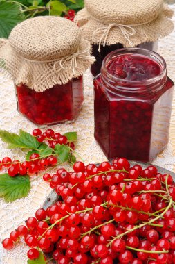 Jars of homemade red currant jam with fresh fruits clipart