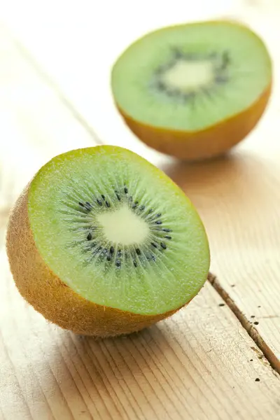 Kiwi fruit on wooden table — Stock Photo, Image