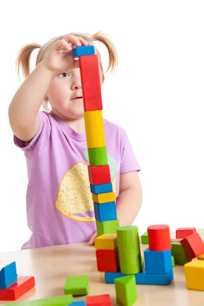 Маленькая девочка играет с игрушечными блоками — стоковое фото