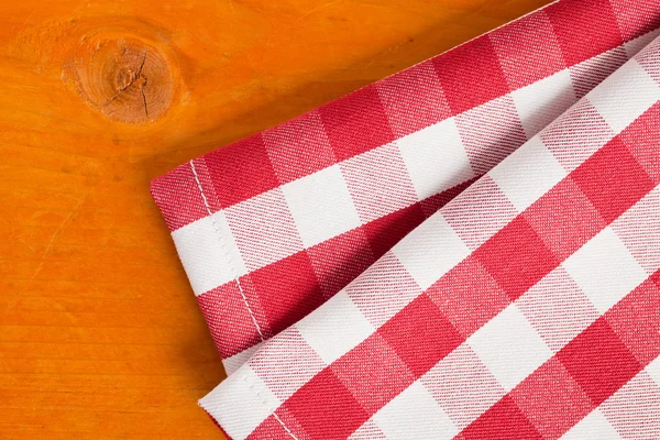 Checkered napkin on wooden table — Stock Photo, Image