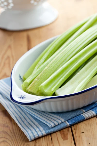 Green celery sticks on kitchen table — Stock Photo, Image