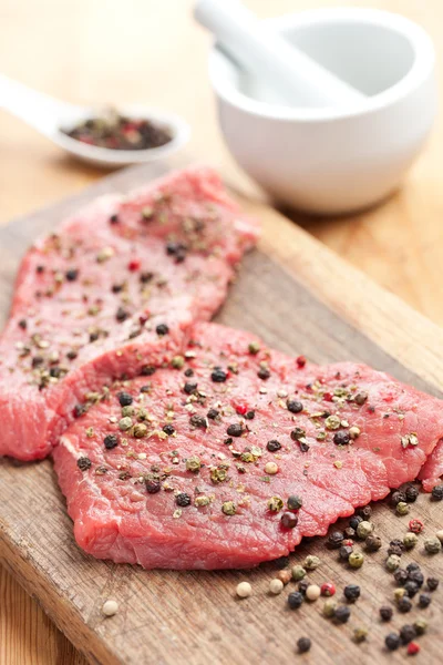 Raw beef steak with pepper — Stock Photo, Image