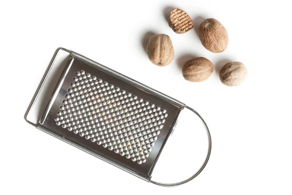 Grind nutmeg with grinder — Stock Photo, Image