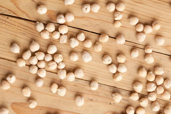 Chickpeas on wooden table — Stock Photo, Image