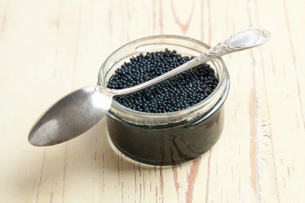 Black caviar in glass jar — Stok fotoğraf