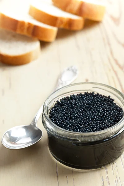Black caviar in glass jar — Stockfoto