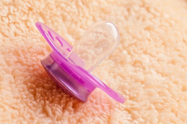 The pacifier on soft background — Stock Photo, Image