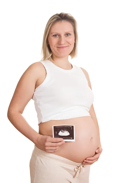 Mujer embarazada sostiene una foto de su ultrasonido — Foto de Stock