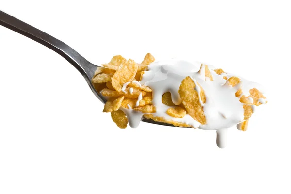 Copos de maíz en la cuchara con leche —  Fotos de Stock
