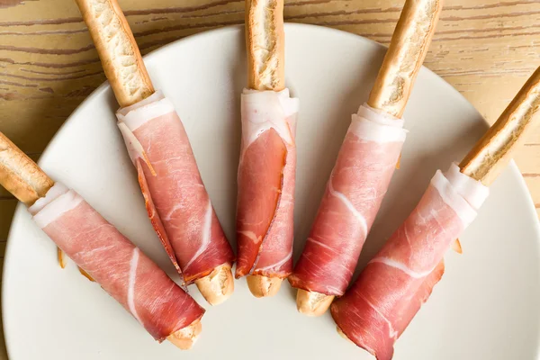 Stock image Grissini sticks with ham