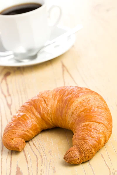 Fresh croissant on wooden table — Stock Photo, Image