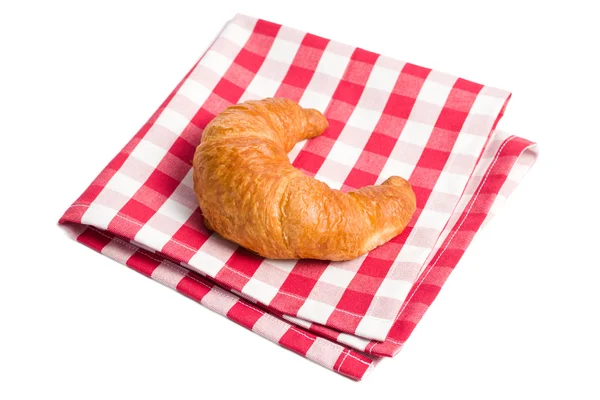 Frische Croissants auf karierter Serviette — Stockfoto