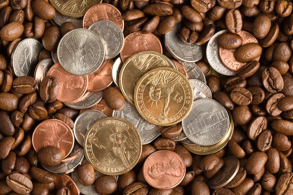 Coins on coffee beans background — Stock Photo, Image