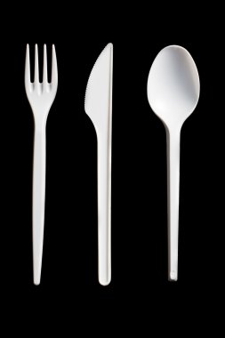 Plastic cutlery on black background clipart