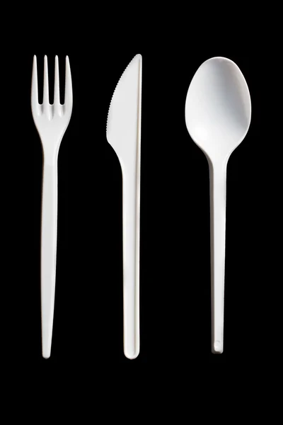Plastic cutlery on black background — Stock Photo, Image