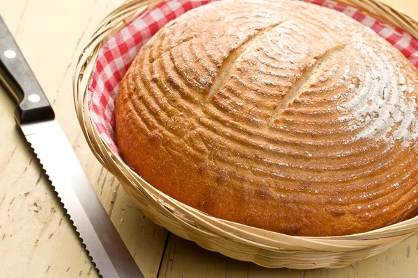 Round bread on kitchen table — Stock Photo, Image
