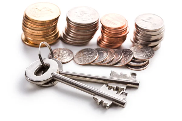 Safe key with coins — Stock Photo, Image