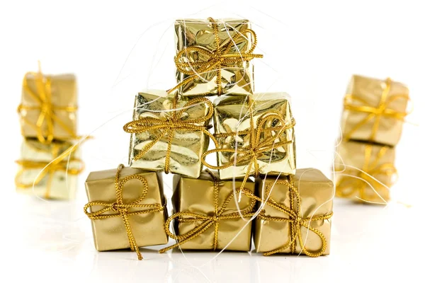 Gold wrapped parcels on a white background — Stock Photo, Image