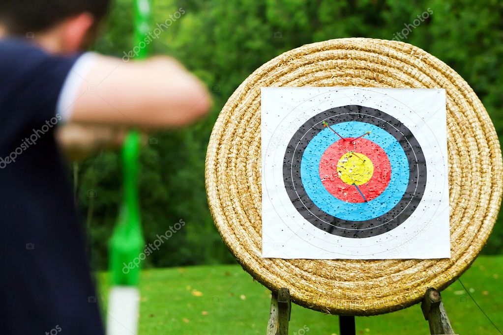 An archer takes aim at target