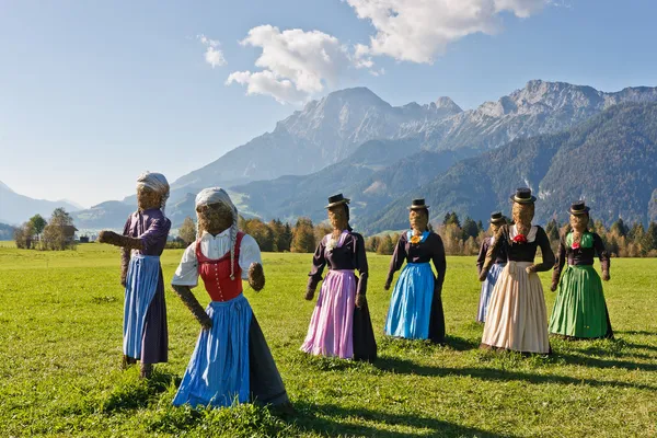 Group of scarecrows in female dress standing on a field — Stock Photo, Image