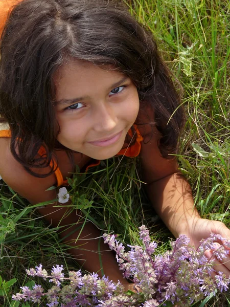 Uma menina bonita com um buquê de flores silvestres — Fotografia de Stock