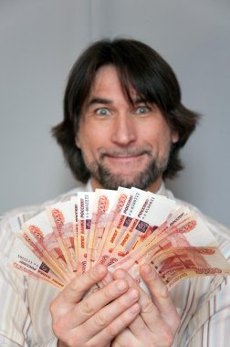 Funny man with a fan of Russian money in the hands of clipart