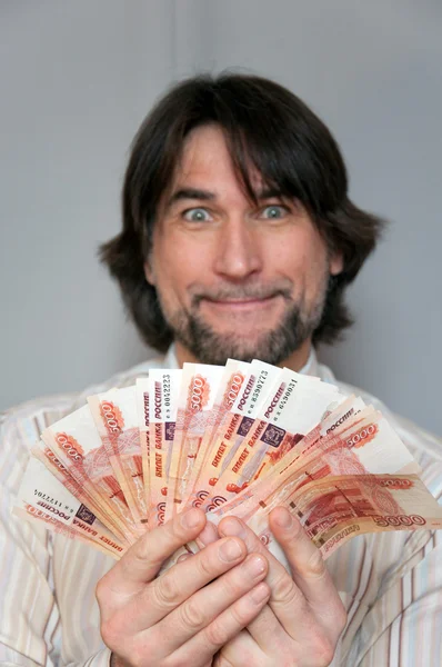 Funny man with a fan of Russian money in the hands of — Stock Photo, Image