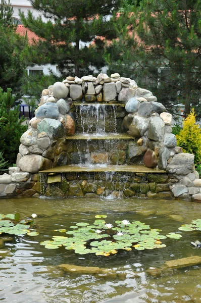 Landscaping - pond with rock slide and waterfall — Stock Photo, Image
