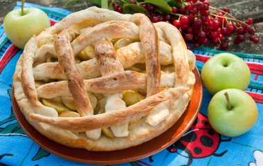 Homemade cake with apples and red cherry