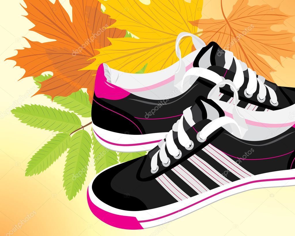 Pair of black sneakers on the autumn background