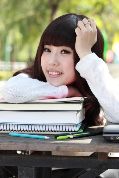 Uśmiechający się azjatycki student studiuje. — Zdjęcie stockowe