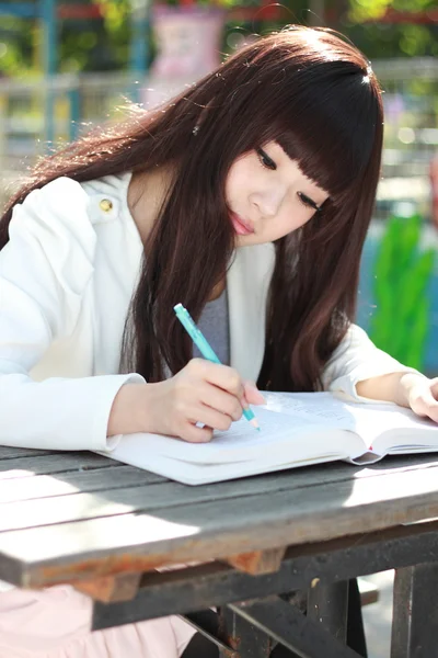 Un étudiant asiatique souriant étudie . — Photo