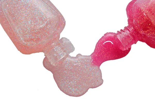 Botella de esmalte de uñas rosa y muestras de gota —  Fotos de Stock