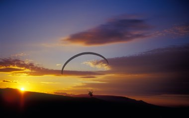 Paraglider at sunset. clipart