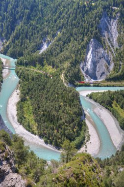 Glacier Express drives besides river Rhine bend clipart