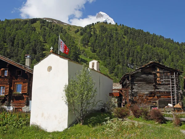 Швейцарская горная деревня с маленькой церковью — стоковое фото