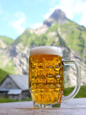 Beer in mountain scenery clipart