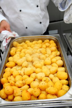 Steaming freshly cooked potatoes in restaurant clipart