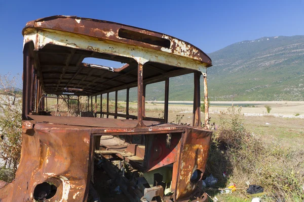 Rusty autobús naufragio en el paisaje árido — Foto de Stock