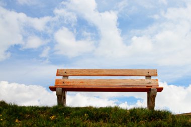 Bench in front of a pretty blue sky clipart