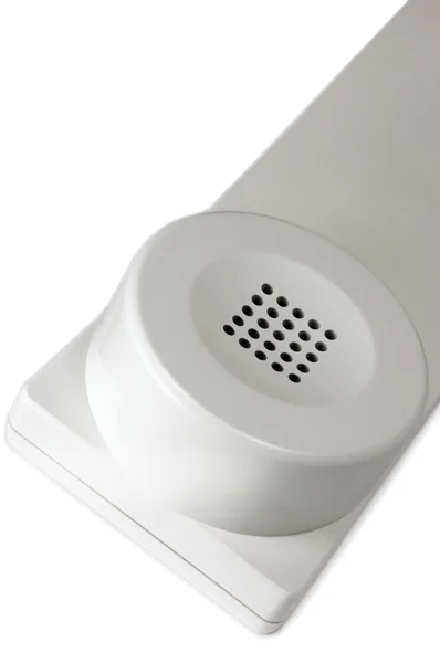 Biały słuchawkę telefonu dłoń makro zbliżenie — Zdjęcie stockowe