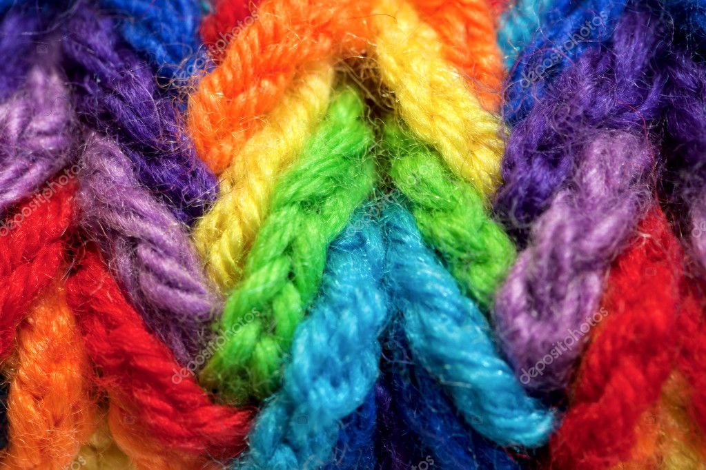 Woolen yarns of different colors, woven in a plait — Stock Photo